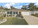 Charming single story house with a well-manicured lawn at 4414 Cameo Cir, The Villages, FL 32163