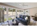 Bright sunroom featuring a comfortable sofa and large windows at 4414 Cameo Cir, The Villages, FL 32163