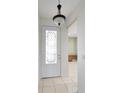 Bright entryway with tile flooring and access to other rooms at 5107 Aurora Dr, Leesburg, FL 34748
