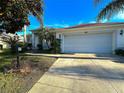 Single story home with a two car garage and walkway at 5336 Tidewater St, Leesburg, FL 34748