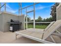 Relaxing poolside patio with lounge chairs and a gas grill at 840 Pebble Beach Dr, Davenport, FL 33896