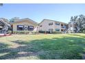 Charming two-story condo building with manicured landscaping and covered parking at 110 N Tremain St # 110, Mount Dora, FL 32757
