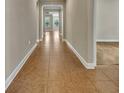 Long hallway with tile flooring and neutral walls at 4200 Foxhound Dr, Clermont, FL 34711