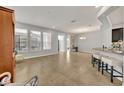 Open floor plan living room with tile floors and a view to the kitchen at 504 Narrow View Ln, Groveland, FL 34736