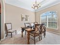 Formal dining room with a large window, chandelier, and stylish table at 11075 Se 173Rd Pl, Summerfield, FL 34491