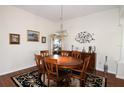 Bright dining room with wood table and chairs, hardwood floors, and decorative art at 1443 Greenville Way, The Villages, FL 32162