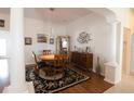 Bright dining room with wood table and chairs, hardwood floors, and decorative art at 1443 Greenville Way, The Villages, FL 32162
