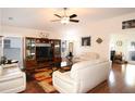 Spacious living room with hardwood floors, comfortable seating, and large windows at 1443 Greenville Way, The Villages, FL 32162