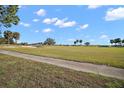 Landscaped golf course with palm trees and lush green fairways at 1730 Augustine Dr, The Villages, FL 32159