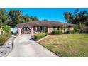 House exterior showcasing a well-maintained lawn and a decorative garage door at 316 Amanda Ln, Leesburg, FL 34748