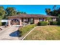 Ranch style home with landscaped yard, decorative fountain, and a circular driveway at 316 Amanda Ln, Leesburg, FL 34748