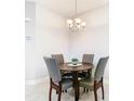 Cozy dining area with a round table and four gray chairs at 8512 Magnificent Ln, Groveland, FL 34736
