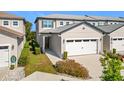 Townhome exterior showcasing a front entrance and garage at 8512 Magnificent Ln, Groveland, FL 34736