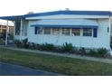 Mobile home with covered porch and attractive landscaping at 117 Hibiscus Way, Leesburg, FL 34748