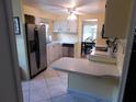 Eat-in kitchen featuring stainless steel appliances and ample counter space at 117 Hibiscus Way, Leesburg, FL 34748