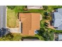 Single-story home with brown roof and landscaped yard, seen from above at 1233 Carvello Dr, The Villages, FL 32162
