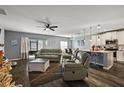 Open-concept living space with gray walls and a modern kitchen at 1270 Stratton Ave, Groveland, FL 34736