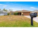 One story house with brown garage door and mailbox at 17329 Se 115Th Terrace Rd, Summerfield, FL 34491