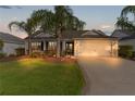 House exterior featuring a two-car garage and landscaping at 2131 Callaway Dr, The Villages, FL 32162