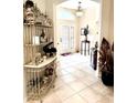 Inviting foyer with tile flooring, decorative shelving, and natural light at 2850 Apache Ct, The Villages, FL 32163