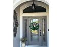 Welcoming front entryway with a decorative glass door and a festive wreath at 2850 Apache Ct, The Villages, FL 32163