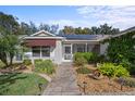 Home's entrance with walkway, landscaping, and screened porch at 3550 Auburndale Ave, The Villages, FL 32162
