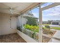 Cozy screened porch with tile flooring and lush greenery at 3550 Auburndale Ave, The Villages, FL 32162