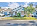 Inviting exterior featuring a charming front porch and well-maintained landscaping at 374 Division St, Clermont, FL 34711