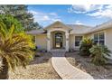 Attractive front entrance with a brick pathway and lush landscaping at 39320 Harbor Hills Blvd, Lady Lake, FL 32159