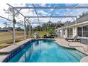 Screened pool with waterfall feature and patio at 39320 Harbor Hills Blvd, Lady Lake, FL 32159