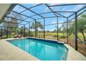 Inviting pool and screen enclosure overlooking the golf course at 5509 Grove Mnr, Lady Lake, FL 32159