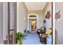 Relaxing front porch with wicker chairs and potted plants at 5717 Illumination Ln, Leesburg, FL 34748