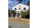 Two-story home with unique architectural details and landscaped yard at 100 W Myrtle St, Howey In The Hills, FL 34737