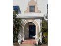 Stylish front entrance featuring a blue door and arched entryway at 100 W Myrtle St, Howey In The Hills, FL 34737