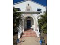 Inviting front porch with tiled steps and arched entryway at 100 W Myrtle St, Howey In The Hills, FL 34737