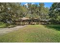 House exterior showcasing a long driveway and lush landscaping at 5415 Banana Point Dr, Okahumpka, FL 34762