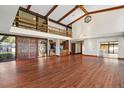 Open living area with hardwood floors, high ceilings, and a loft at 5415 Banana Point Dr, Okahumpka, FL 34762