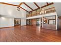High-ceilinged living room with hardwood floors and a view of the kitchen at 5415 Banana Point Dr, Okahumpka, FL 34762