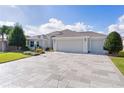 Spacious home with a three-car garage and nicely landscaped front yard at 747 Bradford Loop, The Villages, FL 32163