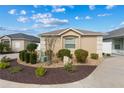 Exterior elevation of a single-story home with landscaping at 867 Parrish Pl, The Villages, FL 32163