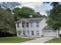 Two-story house with attached garage and yard at 1029 Kirk St, Orlando, FL 32808