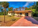 Ranch home with a large yard and palm tree at 11451 Pala Verda Ave, Leesburg, FL 34788