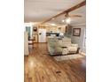 Open living area with light wood floors, ceiling fan and comfortable seating at 12141 Lake Pines Rd, Leesburg, FL 34788