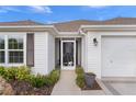 Front entrance with screen door and landscaping at 4318 St Stephen St, The Villages, FL 32163