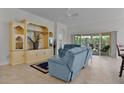 Living room with built-in entertainment center and blue couches at 4318 St Stephen St, The Villages, FL 32163