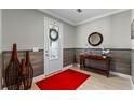 Bright entryway with red rug, wood-look walls, and decorative accents at 771 Annabell Ridge Rd, Minneola, FL 34715