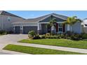 Two-story home with gray siding, red accents, and a lush lawn at 771 Annabell Ridge Rd, Minneola, FL 34715