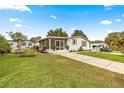 Front view of a home with screened porch at 811 Saint Andrews Blvd, The Villages, FL 32159