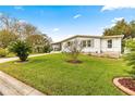 Well-maintained home with lush green lawn at 811 Saint Andrews Blvd, The Villages, FL 32159