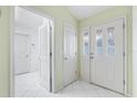 Bright entryway with white doors and tiled floor at 9199 Se 171St Cooper Loop, The Villages, FL 32162